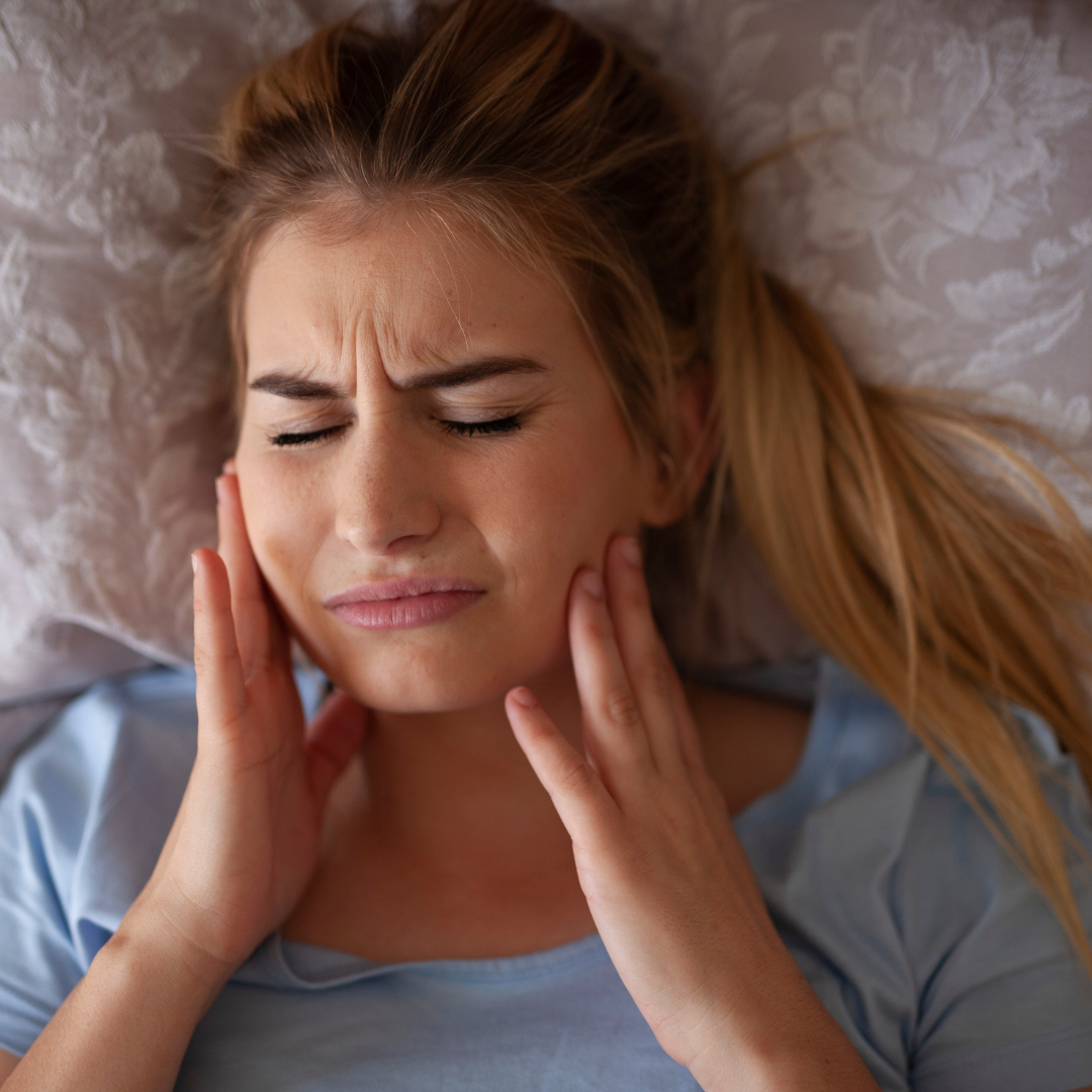 Person experiencing jaw pain from TMJ